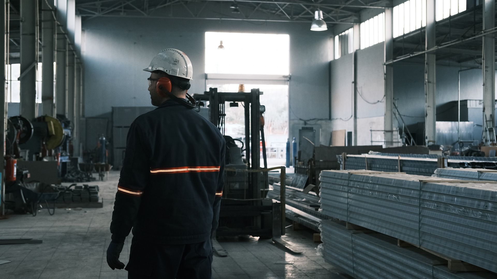 A technician walking the floor of a working plant