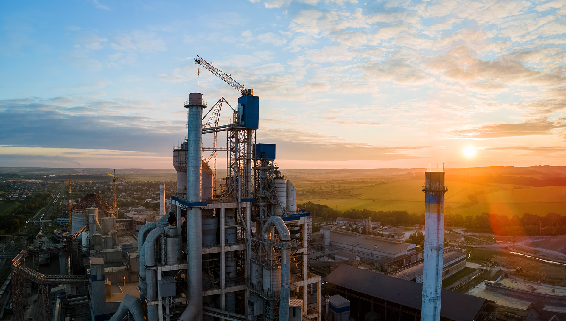 Cement works at sunset — one of the industries Ultron protects